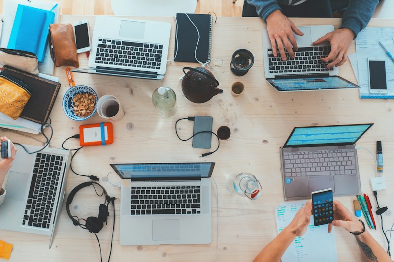 Team using connected digital tools, representing coordinated customer lifecycle workflows