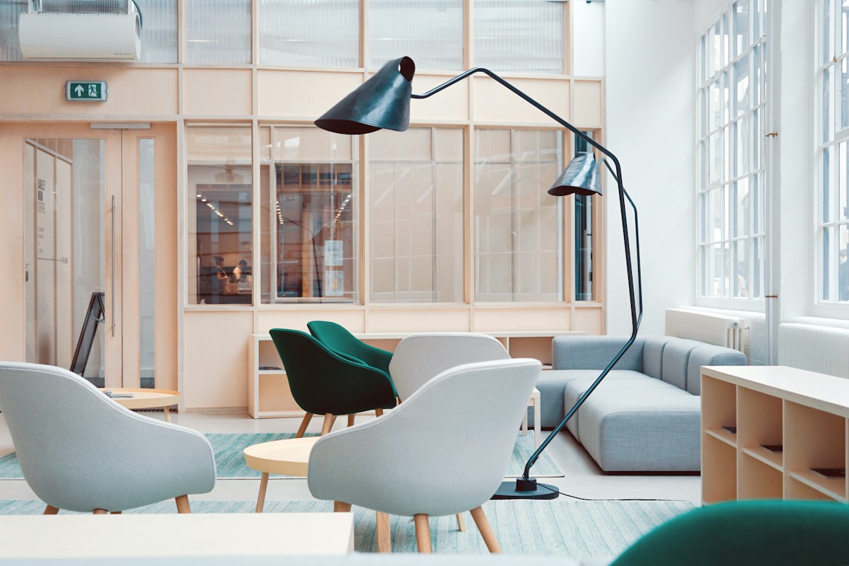 Open creative workspace with shared tables and natural light, illustrating multidisciplinary collaboration