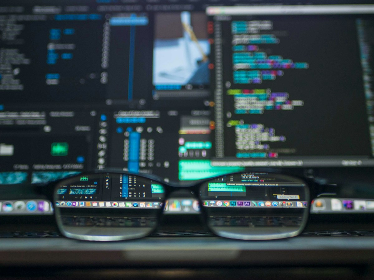 Computer displays with programming tools, illustrating resilient engineering and extensible digital systems